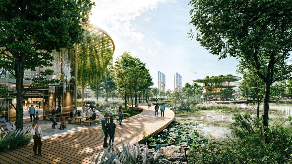 Hình ảnh khu vực lối đi bộ bằng gỗ ven hồ trong dự án Sun Group Mê Linh, bao quanh bởi cây xanh, hoa sen và các công trình kiến trúc hiện đại với thiết kế xanh, mở; nhiều cư dân đang tản bộ, thư giãn, trò chuyện.